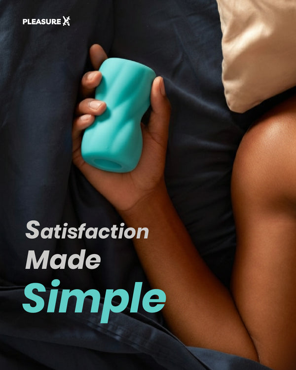 Person holding a teal toy with 'Pleasure X' branding and text 'Satisfaction Made Simple' of male mastrubation sex toy